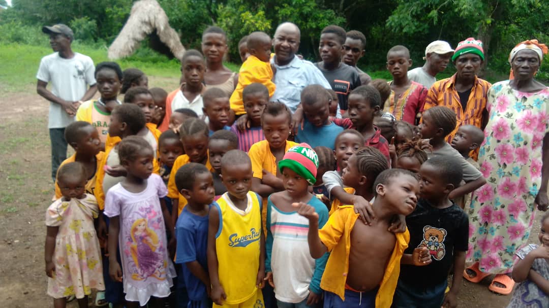Group photo of children and community members in a Sierra Leone village